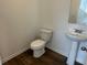 Well-lit half bathroom featuring a pedestal sink and modern fixtures at 2105 Boxwood Se Cir, Conyers, GA 30094