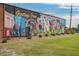 Colorful 'Greetings From Concord' mural adorns the exterior of a brick building, surrounded by a green lawn at 2105 Boxwood Se Cir, Conyers, GA 30094