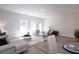 Bright living room with modern furniture, wood floors, and natural light from large windows at 4960 Villager Ln, Stone Mountain, GA 30083