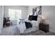 Main bedroom with neutral decor, a large window, and a patterned rug at 4960 Villager Ln, Stone Mountain, GA 30083