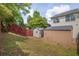 Lawn with fenced-in backyard featuring two storage sheds, blending functionality with outdoor charm at 7293 Bridlewood Ct, Jonesboro, GA 30236