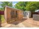 View of backyard with two sheds on a brick-paved patio, offering ample storage space for outdoor equipment at 7293 Bridlewood Ct, Jonesboro, GA 30236