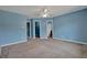 Large bedroom with light blue walls and neutral carpeting at 7293 Bridlewood Ct, Jonesboro, GA 30236