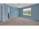 Spacious bedroom features blue walls, neutral carpet, and natural light from large windows at 7293 Bridlewood Ct, Jonesboro, GA 30236