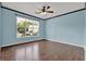 Comfortable bedroom with hardwood floors, large window, and a ceiling fan at 7293 Bridlewood Ct, Jonesboro, GA 30236