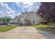 Pleasant townhome featuring a green lawn, a mature tree, and a designated parking space at 7293 Bridlewood Ct, Jonesboro, GA 30236