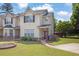 Attractive townhome showcasing a well-kept lawn, tidy landscaping, and a welcoming entrance at 7293 Bridlewood Ct, Jonesboro, GA 30236