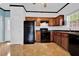Functional kitchen featuring wooden cabinets, black appliances, and tile flooring at 7293 Bridlewood Ct, Jonesboro, GA 30236