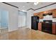 Eat-in kitchen with wooden cabinets, black appliances, and easy access to other rooms at 7293 Bridlewood Ct, Jonesboro, GA 30236