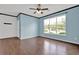 Bright living room with hardwood floors, a ceiling fan, and a large window at 7293 Bridlewood Ct, Jonesboro, GA 30236
