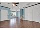 Spacious living room features hardwood floors, a ceiling fan, and ample natural light at 7293 Bridlewood Ct, Jonesboro, GA 30236