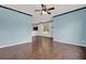 Open-concept living room with hardwood floors, a view into the kitchen, and natural light at 7293 Bridlewood Ct, Jonesboro, GA 30236