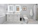 Bright bathroom featuring double vanity with lighted mirrors, marble floors, and walk-in shower at 991 Metropolitan Sw Pkwy, Atlanta, GA 30310