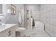 Elegant bathroom boasts marble tile, glass shower, and a modern soaking tub at 991 Metropolitan Sw Pkwy, Atlanta, GA 30310