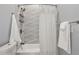 Clean bathroom with tub and shower combination with decorative tiled walls at 991 Metropolitan Sw Pkwy, Atlanta, GA 30310
