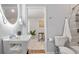 Modern bathroom featuring an illuminated mirror, stylish sink, and tiled shower at 991 Metropolitan Sw Pkwy, Atlanta, GA 30310