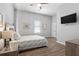 Cozy bedroom with wood floors, ceiling fan, and mounted television at 991 Metropolitan Sw Pkwy, Atlanta, GA 30310
