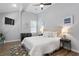 Bright bedroom with a ceiling fan, wood floors, and a plush white bedspread at 991 Metropolitan Sw Pkwy, Atlanta, GA 30310