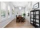 Dining room with a long wooden table and a modern light fixture at 991 Metropolitan Sw Pkwy, Atlanta, GA 30310
