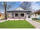 Charming renovated home featuring a welcoming front porch and a beautifully landscaped yard at 991 Metropolitan Sw Pkwy, Atlanta, GA 30310