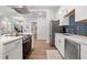 Well-lit kitchen with stainless steel appliances, light countertops, and hardwood floors at 991 Metropolitan Sw Pkwy, Atlanta, GA 30310