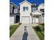 New construction two-story home with white and gray siding, a one car garage, and landscaping at 4011 Redan Rd # 9, Stone Mountain, GA 30083