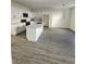 Modern kitchen features white cabinets, stainless steel appliances, and a center island with a marble countertop at 4011 Redan Rd # 9, Stone Mountain, GA 30083