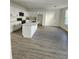 Modern kitchen features white cabinets, stainless steel appliances, and a center island with a marble countertop at 4011 Redan Rd # 9, Stone Mountain, GA 30083