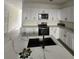 Modern kitchen featuring white cabinets, stainless steel appliances, and a center island at 4011 Redan Rd # 9, Stone Mountain, GA 30083