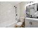 Bathroom features a shower, white tile and updated black hardware and fixtures at 4742 West Dr, Forest Park, GA 30297