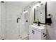 Modern bathroom featuring subway tile walls, a glass-enclosed shower, and stylish vanity at 4742 West Dr, Forest Park, GA 30297