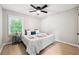 This is a bedroom with a light wood floor, ceiling fan, and a window with natural light at 4742 West Dr, Forest Park, GA 30297