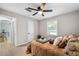 Comfortable bedroom features natural light, ceiling fan, and bright wood floor at 4742 West Dr, Forest Park, GA 30297
