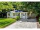 Quaint, light-colored home with a charming screened-in porch and detached garage at 4742 West Dr, Forest Park, GA 30297
