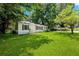 Charming cottage-style home featuring a well-manicured lawn and mature trees at 4742 West Dr, Forest Park, GA 30297