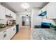 Bright kitchen features white cabinets, granite countertops and hardwood floors at 4742 West Dr, Forest Park, GA 30297