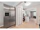 Stainless steel refrigerator next to kitchen featuring modern stove and storage at 4742 West Dr, Forest Park, GA 30297