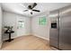 View of the stainless steel refrigerator next to a dinette with fan at 4742 West Dr, Forest Park, GA 30297