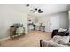Inviting living room features hardwood floors, a modern ceiling fan, and easy access to kitchen at 4742 West Dr, Forest Park, GA 30297