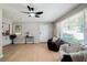 Bright living room with hardwood floors, large windows and ceiling fan at 4742 West Dr, Forest Park, GA 30297