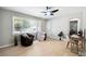 Bright living room with hardwood floors, ceiling fan, a large window, and neutral paint color at 4742 West Dr, Forest Park, GA 30297