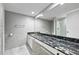 Bathroom with large vanity and granite counters, plus walk-in shower at 6851 Ne Roswell Rd # C4, Atlanta, GA 30328