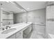 Bright bathroom features a double vanity and spacious, tiled walk-in shower at 6851 Ne Roswell Rd # C4, Atlanta, GA 30328