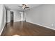 Large bedroom features hardwood flooring, a ceiling fan, and an ensuite bath for convenience at 6851 Ne Roswell Rd # C4, Atlanta, GA 30328