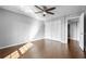 Sunlit bedroom featuring a ceiling fan and wood-look floors at 6851 Ne Roswell Rd # C4, Atlanta, GA 30328