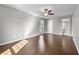 Spacious bedroom featuring hardwood floors, ceiling fan, and ample natural light from the window at 6851 Ne Roswell Rd # C4, Atlanta, GA 30328