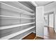 Ample storage space is provided with wooden shelving inside of the walk-in closet at 6851 Ne Roswell Rd # C4, Atlanta, GA 30328