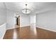 Dining area with hardwood floors, modern light fixture, and an open layout at 6851 Ne Roswell Rd # C4, Atlanta, GA 30328