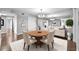 Bright dining area featuring modern chandelier, wood table, and white buffet at 6851 Ne Roswell Rd # C4, Atlanta, GA 30328