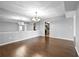 Open dining area with hardwood floors, bright light fixture, and easy access to kitchen at 6851 Ne Roswell Rd # C4, Atlanta, GA 30328